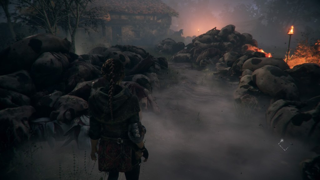 Amicia stands in front of a path to a house with piles of dead cows on either side. There's also a horse and some torches in the background.