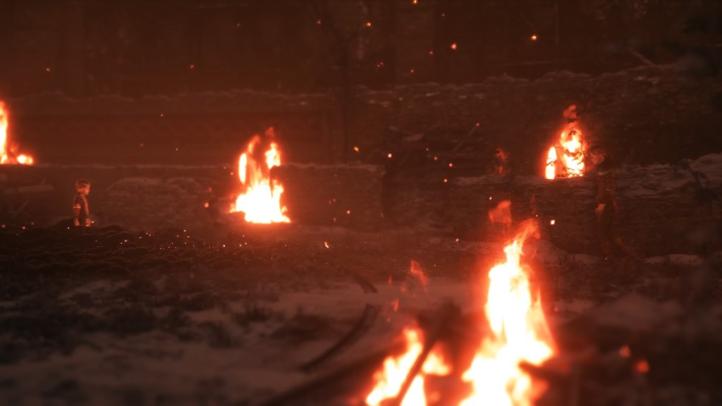 Hugo surrounded by rats on one side, Amicia on the other. They're surrounded by snow and fire. 